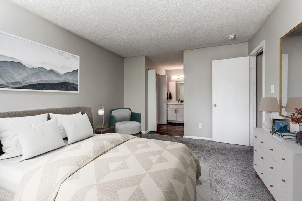 a bedroom with a large bed and a bathroom