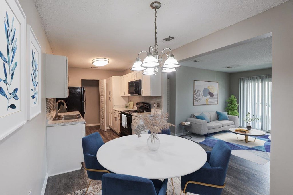 an open living room and kitchen with a table and chairs