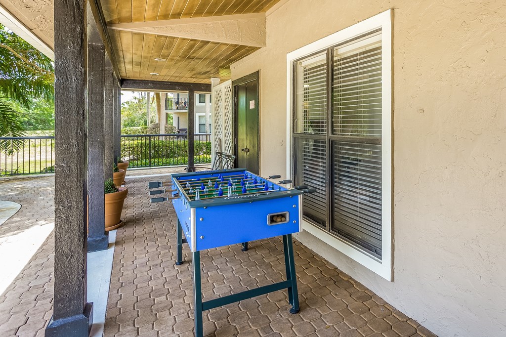 a blue ping pong table on a porch