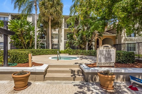 a fountain with a no diving sign in front of an apartment building