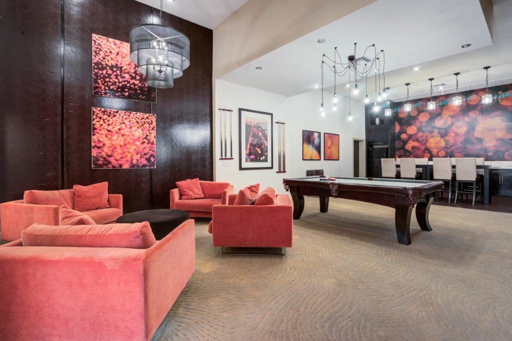 a game room with a pool table and couches