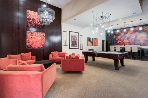 a game room with a pool table and couches