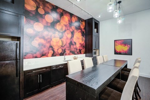 a kitchen with a table and chairs and a refrigerator