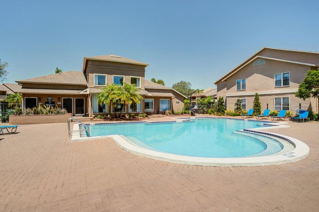 a swimming pool with a house in the background