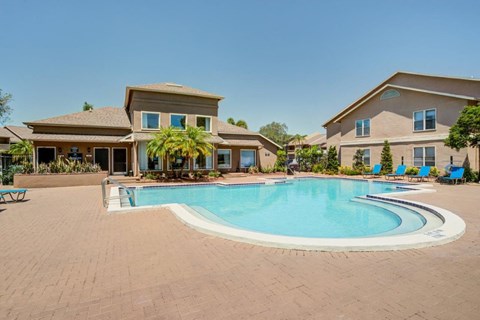 a swimming pool with a house in the background