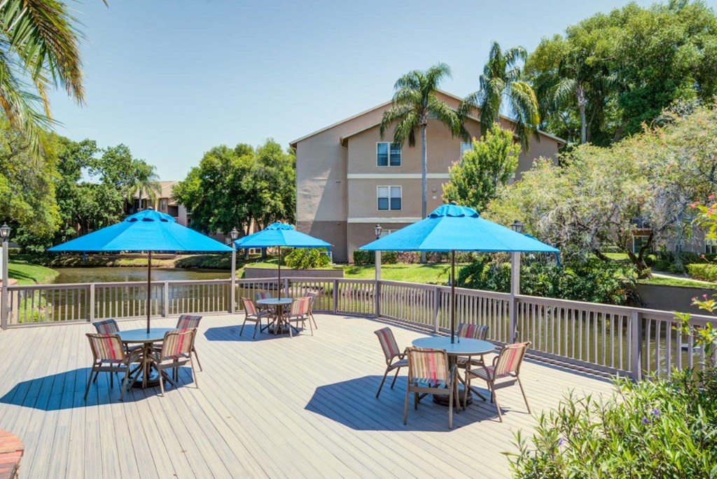 a patio with tables and umbrellas