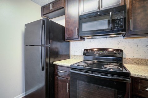 a kitchen with a stove microwave and refrigerator