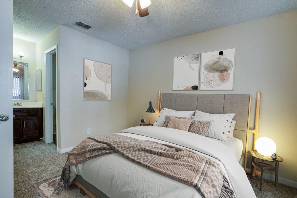 a bedroom with a large bed and a mirror