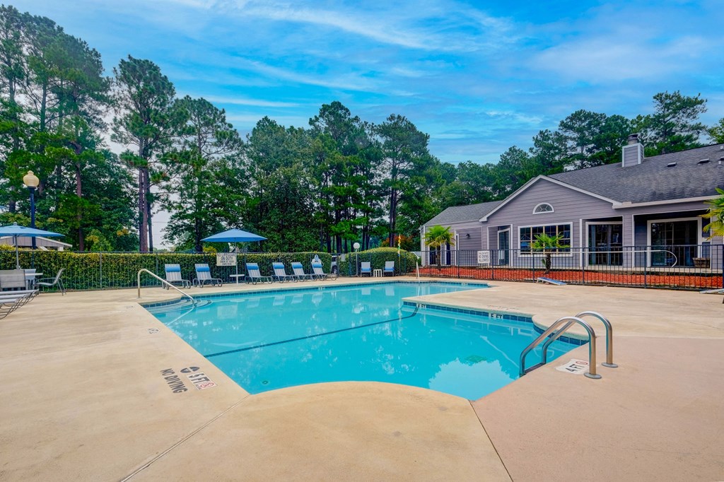 a swimming pool with a house in the background
