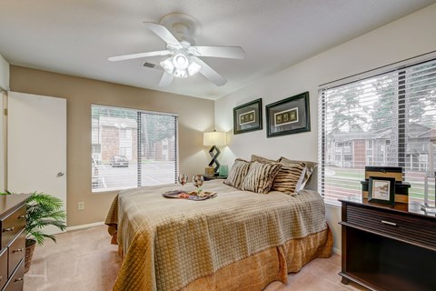 a bedroom with a large bed and a ceiling fan