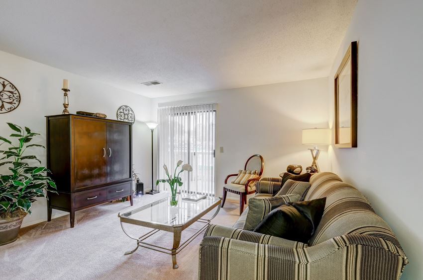 a living room with a couch and a glass coffee table