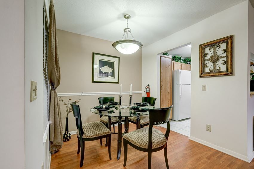 a dining room with a table and chairs and a kitchen