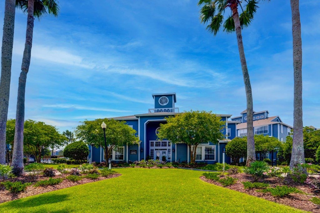 a blue building with palm trees in front of it