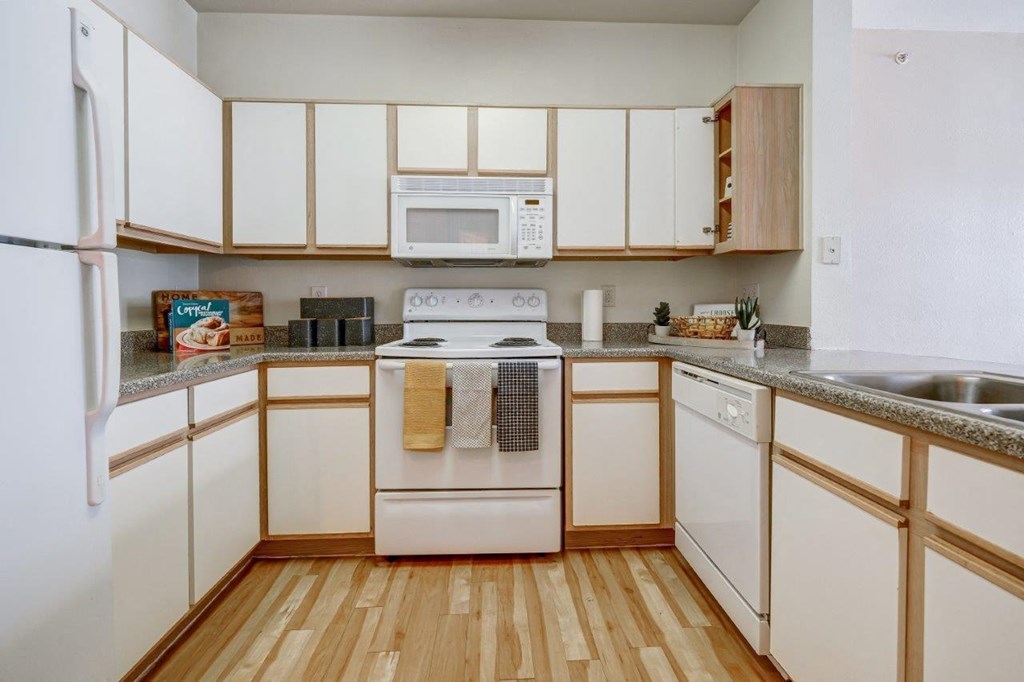 the preserve at ballantyne commons apartment kitchen with white cabinets and appliances