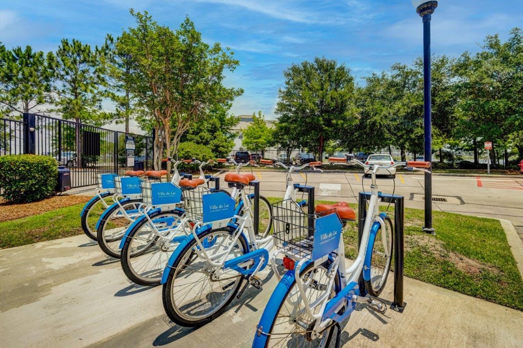 a row of blue bikes parked in a parking lot
