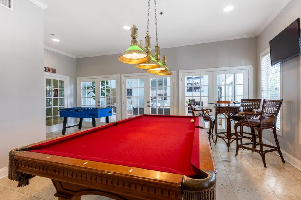 a pool table in a game room with a blue table