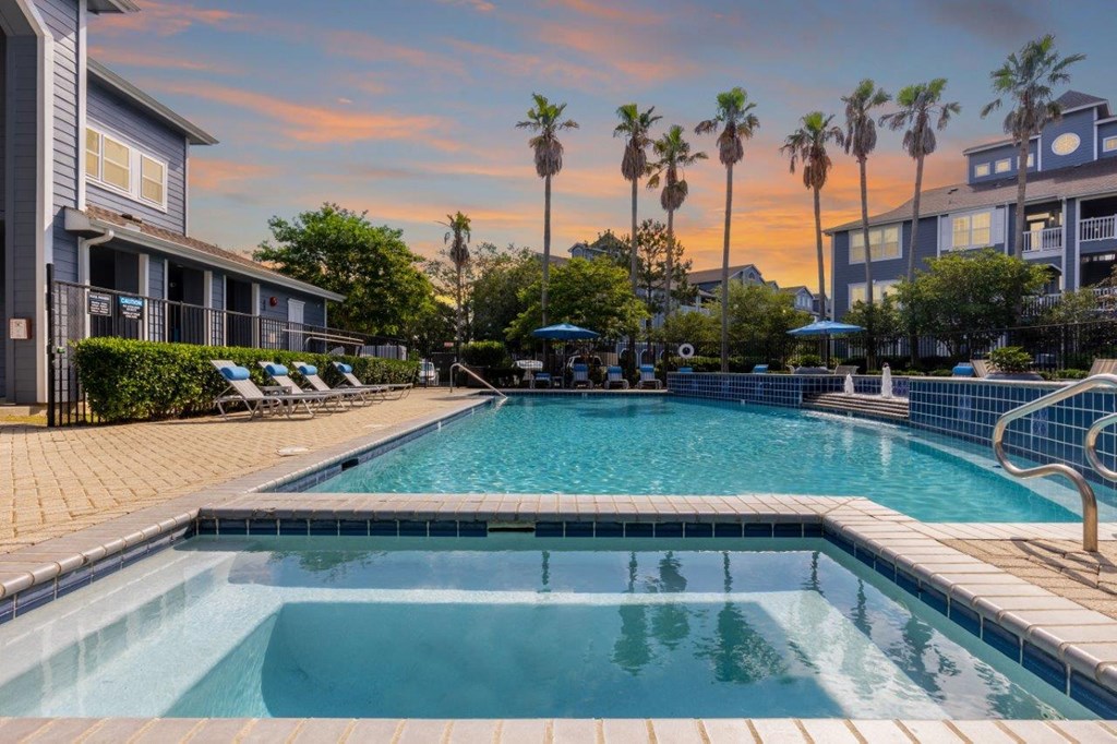 a swimming pool with palm trees in the background