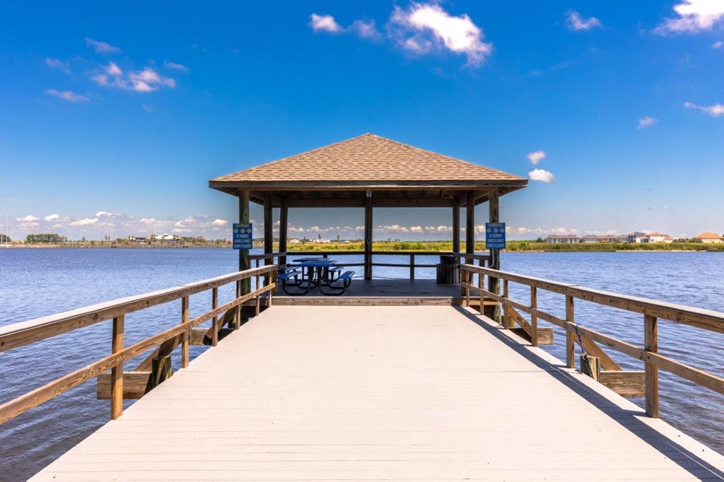 a dock with a gazebo on the water