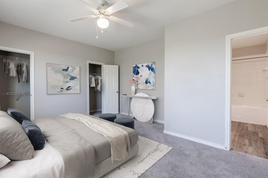 a bedroom with a bed and a ceiling fan