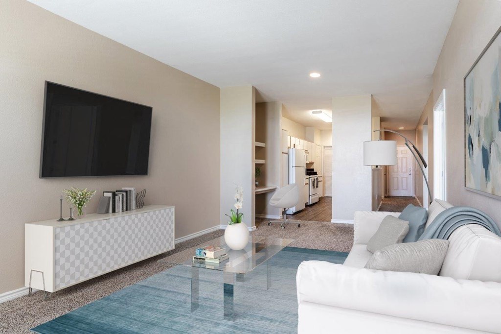 a living room with a white couch and a glass table