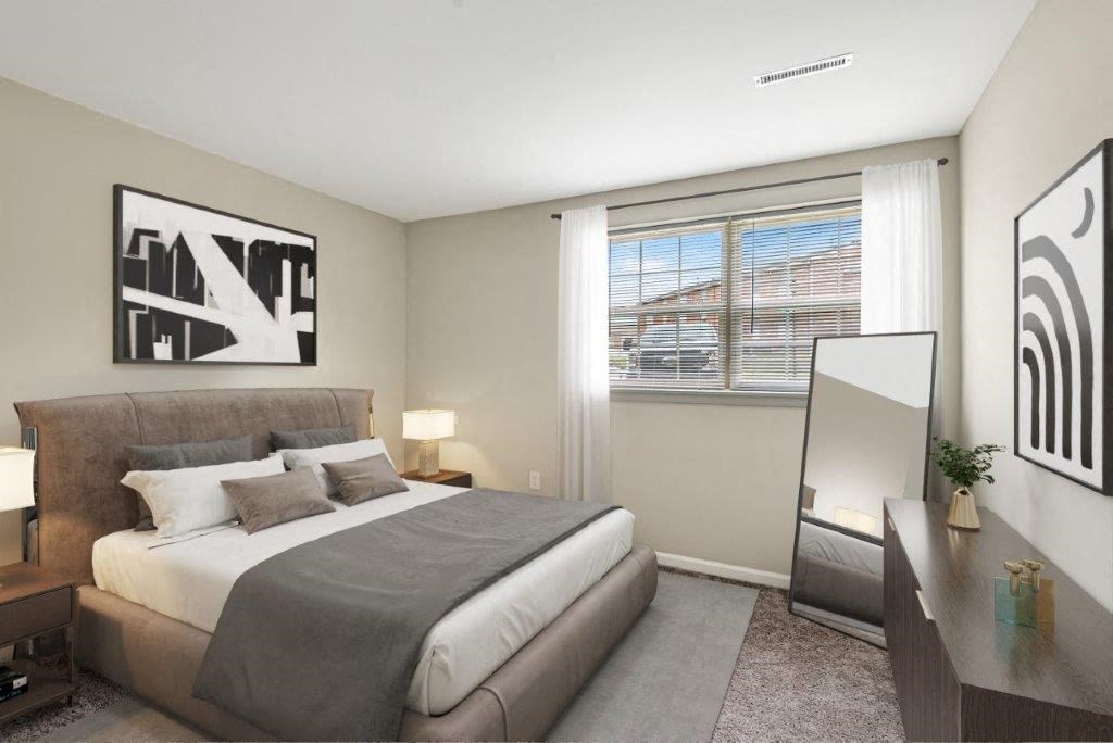 a bedroom with a bed and a large window