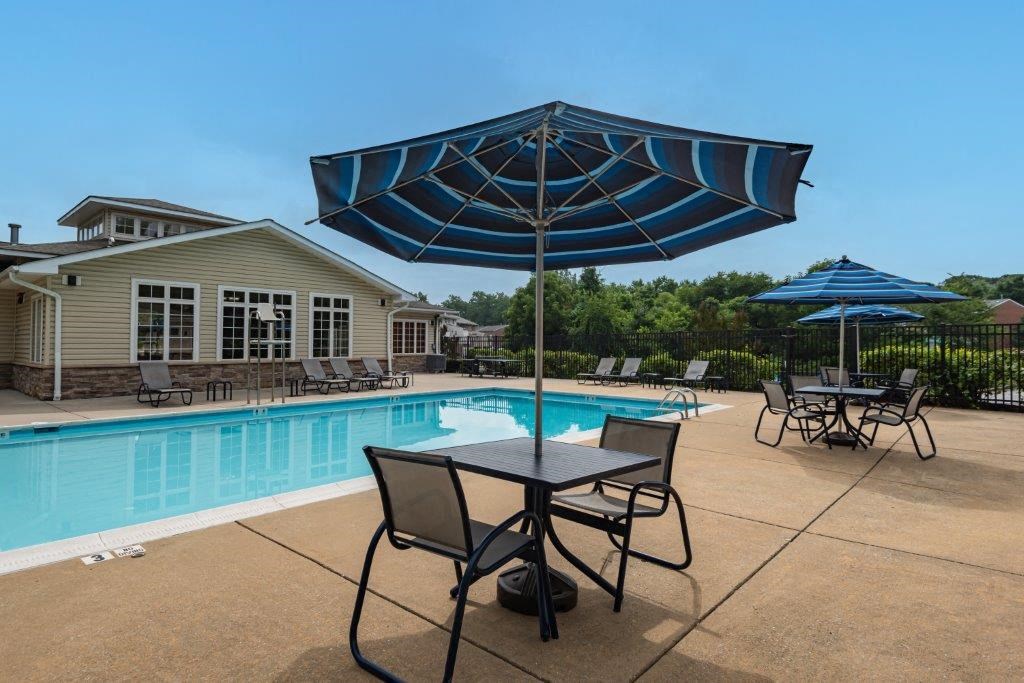 our apartments have a pool and patio with tables and umbrellas