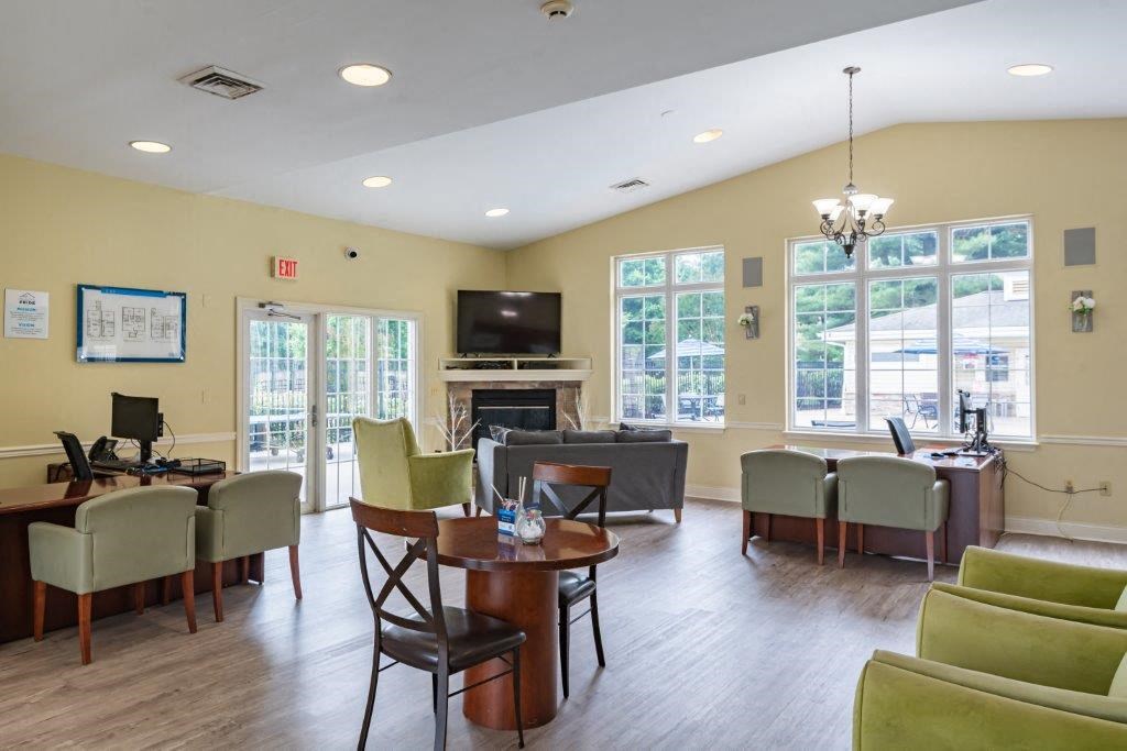 a living room with a table and chairs and a television