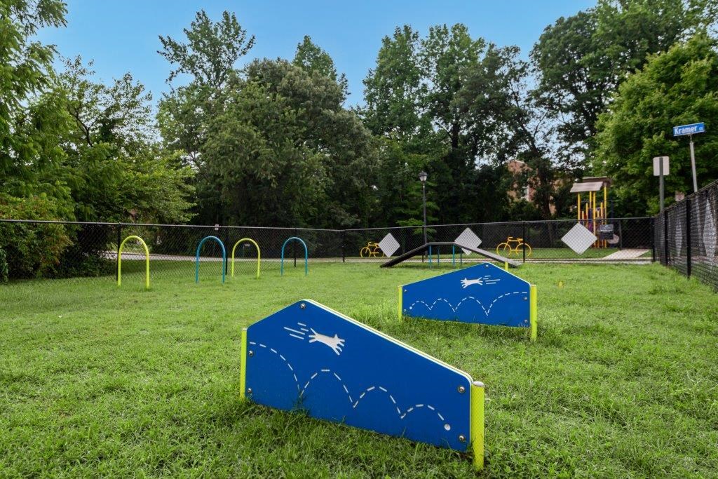 a park with a playground and some hoops on the grass