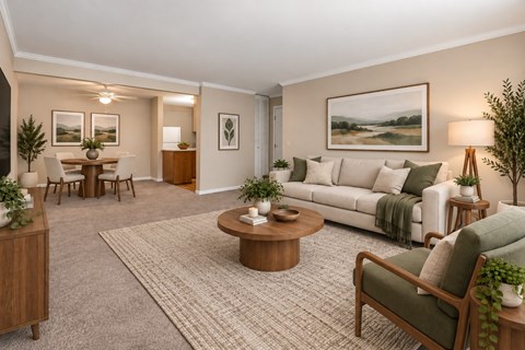 A living room with a white couch, a coffee table, and a painting on the wall.