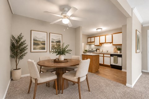 A dining room with a round table and chairs.