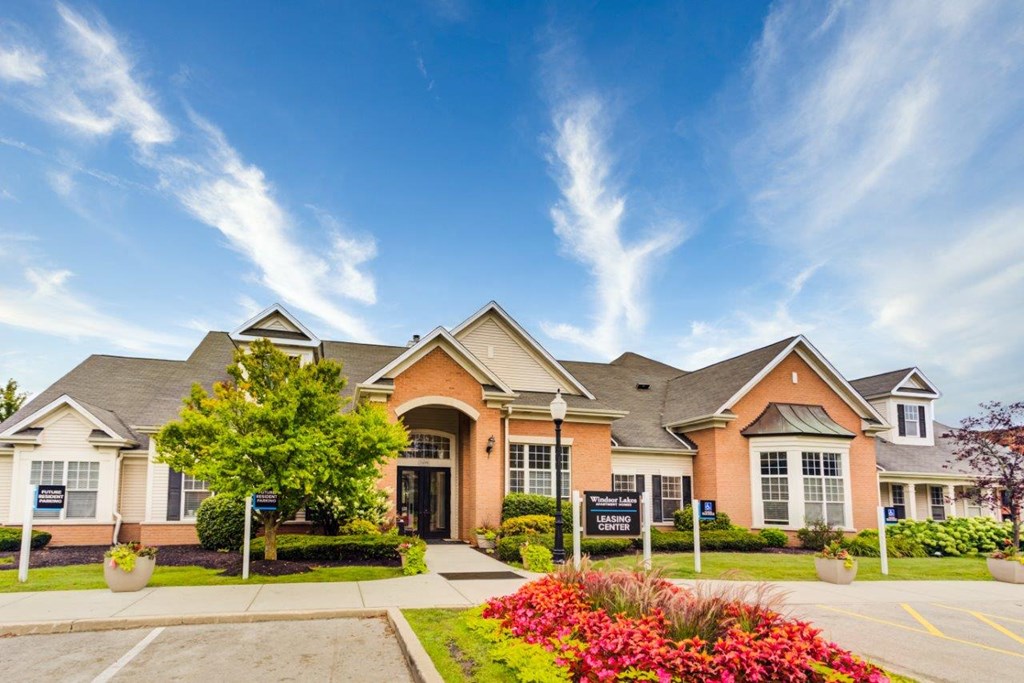 the front exterior of a house with a driveway and landscaping