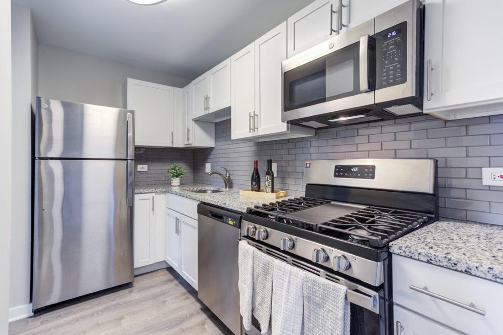 a kitchen with stainless steel appliances and white cabinets