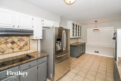 a kitchen with stainless steel appliances and white cabinets