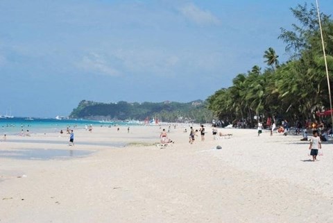 A beach scene with people enjoying the sun and sand.
