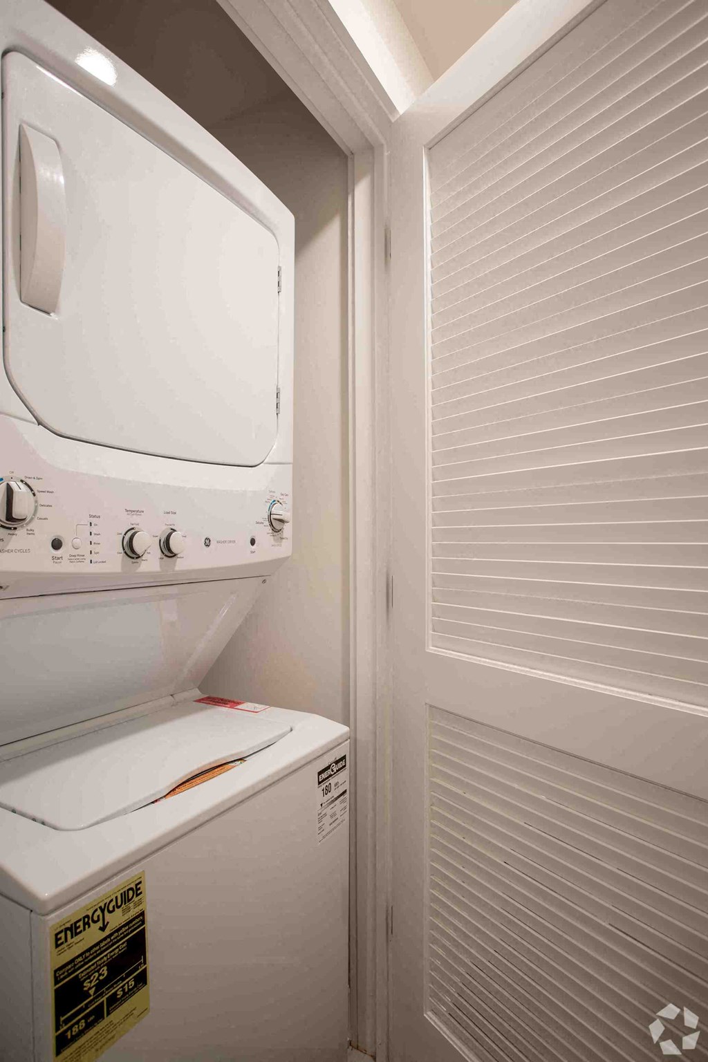 a washer and dryer in a laundry room with a closet