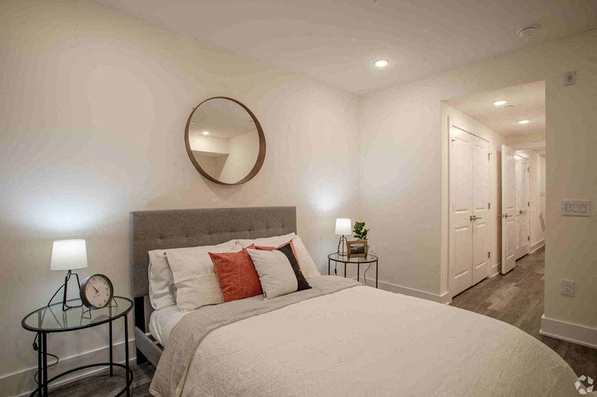 a bedroom with a large bed and a mirror
