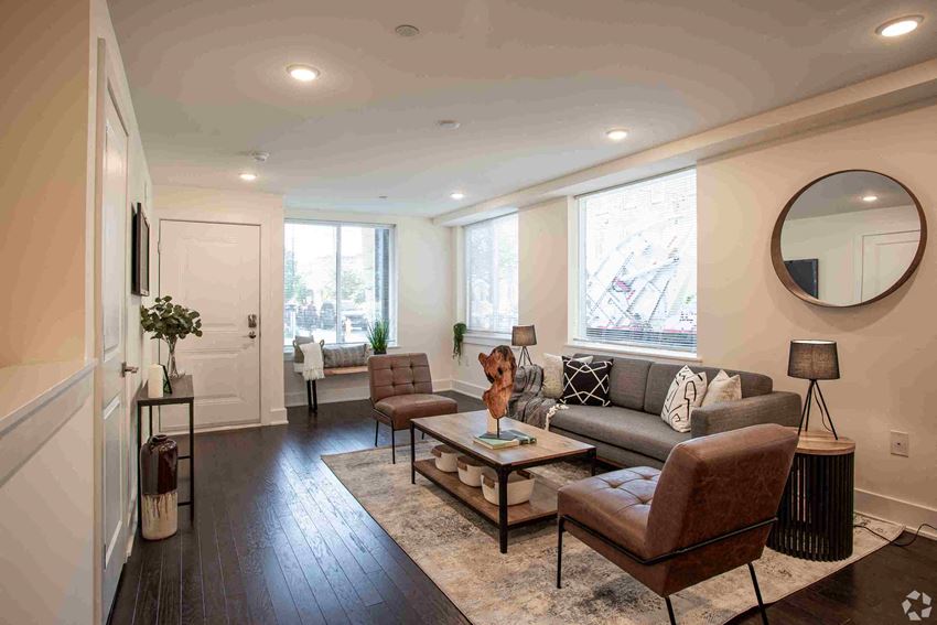 a living room with a couch and chairs and a table