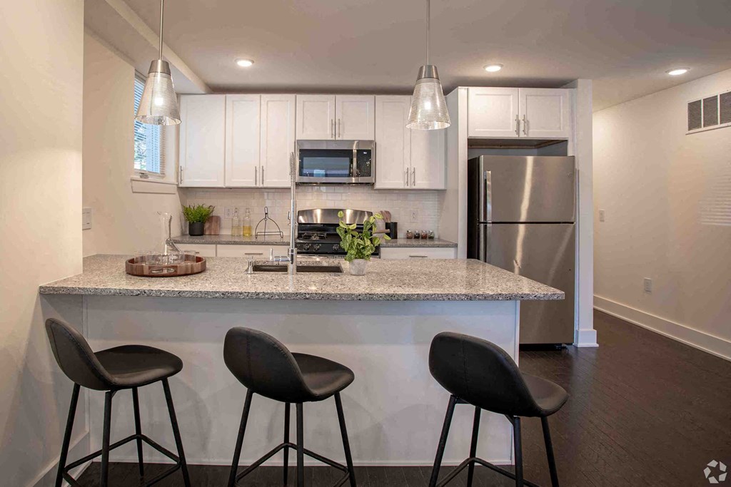 a kitchen with a island and three stools