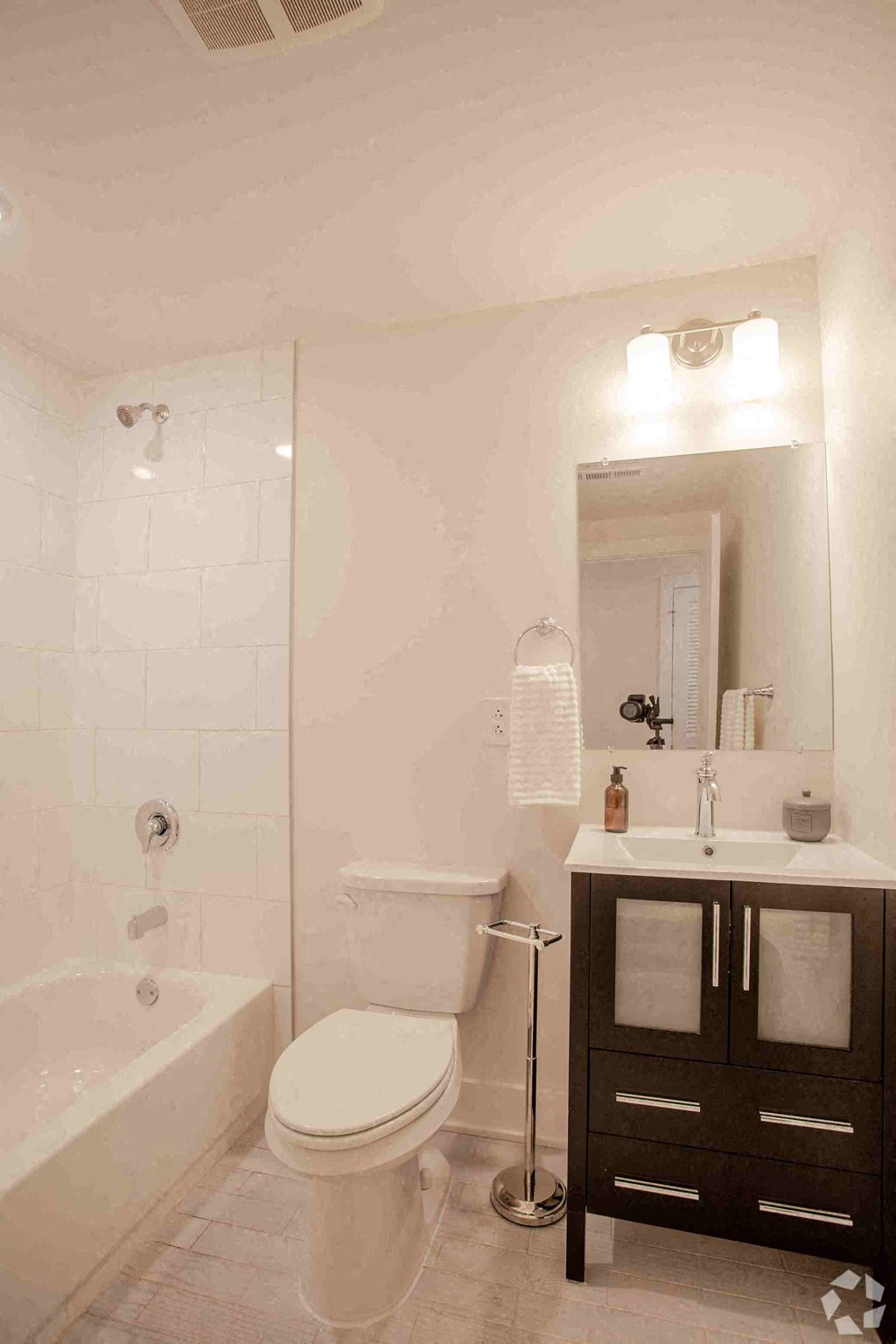 a bathroom with a toilet and a sink and a shower