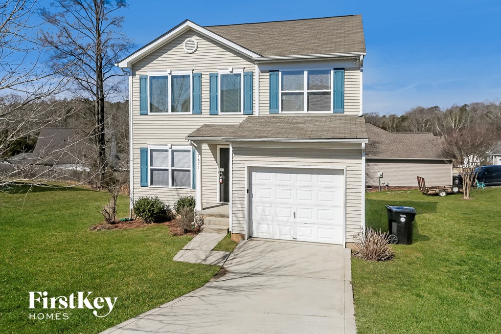 A two-story house with a garage is for sale.