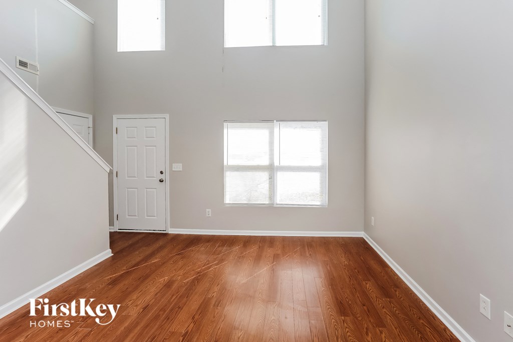 A room with wooden floors and a white door.
