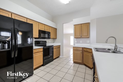 a kitchen with black appliances and wooden cabinets