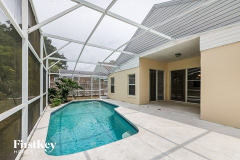 a swimming pool in the backyard of a house with a glass roof