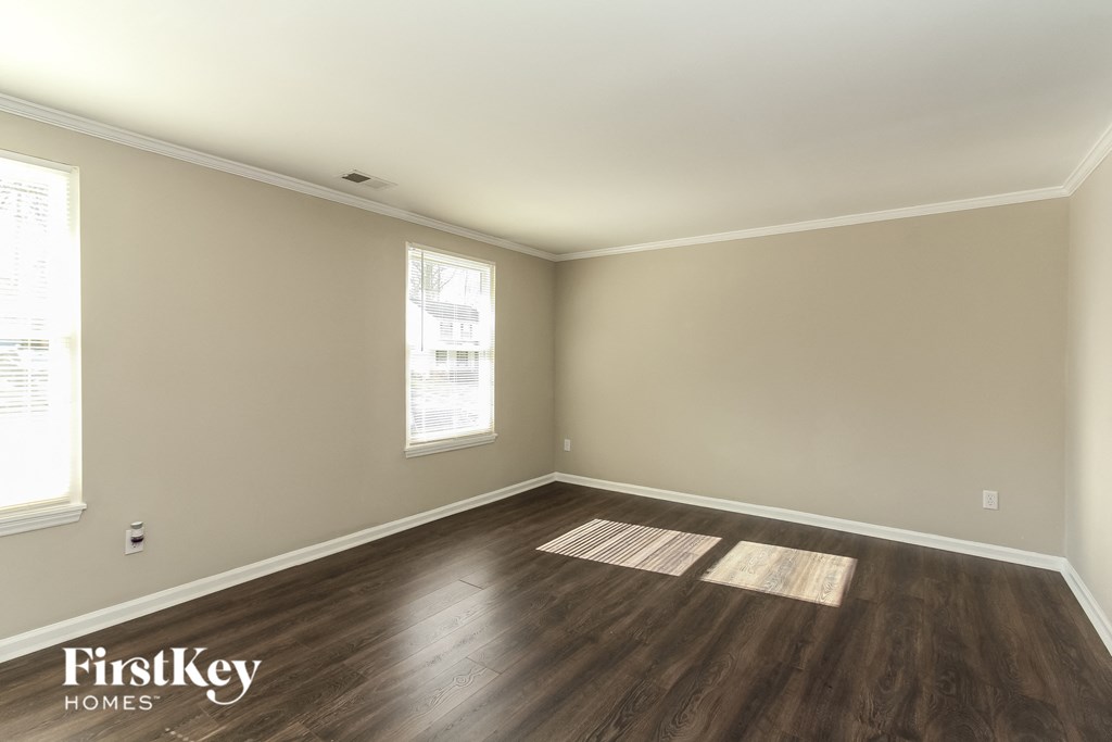 A room with wooden floors and a window.