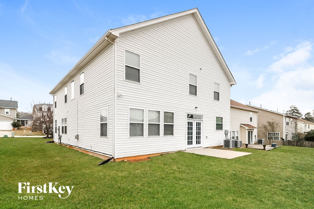 a white house with a lawn in front of it