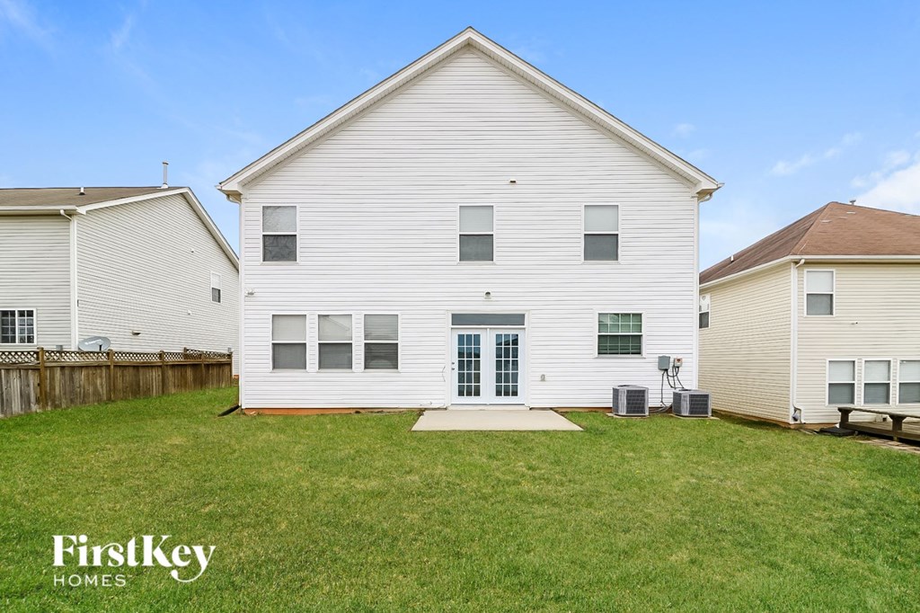 a white house with a yard in front of it