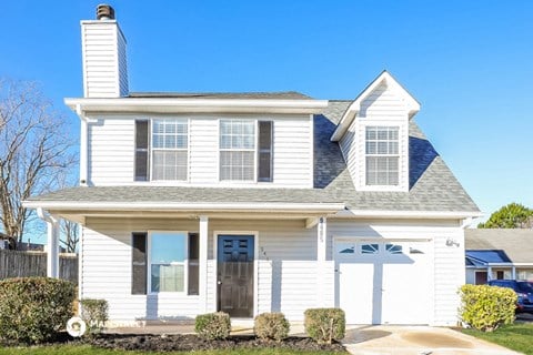 a white house with white siding and a blue roof