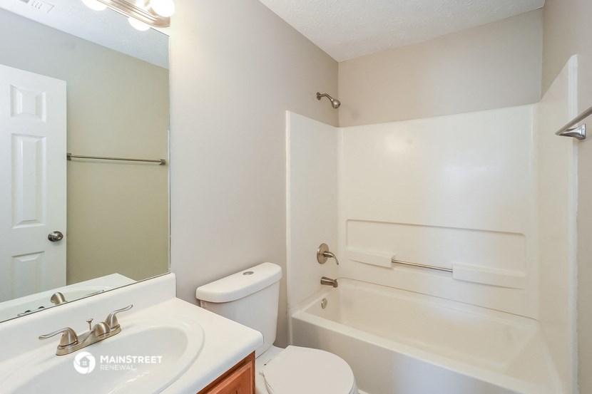 a bathroom with a sink toilet and a bath tub