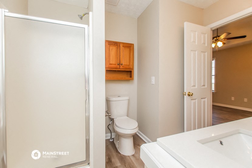 a bathroom with a toilet and a sink and a mirror