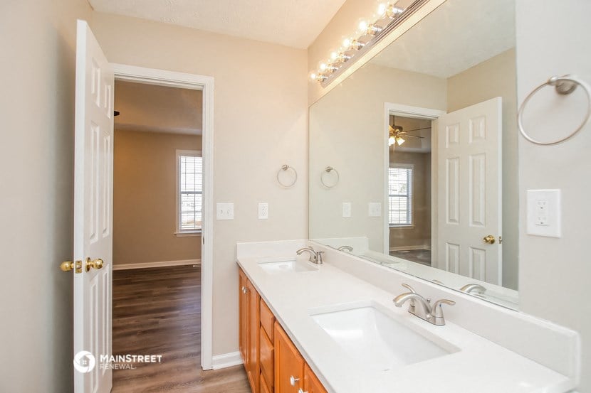an empty bathroom with a sink and a mirror